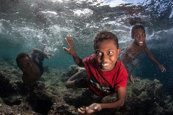 Snorkeling in the Solomon Islands with local children